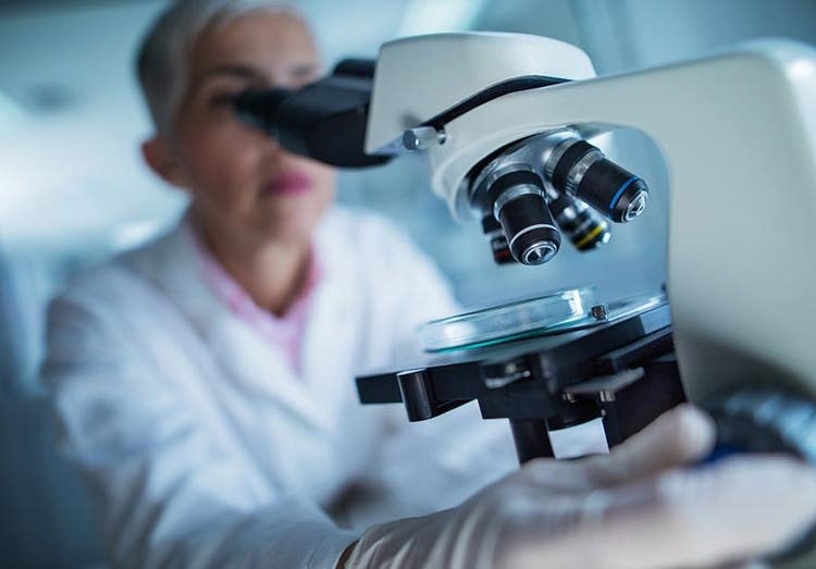 Woman looking through microscope